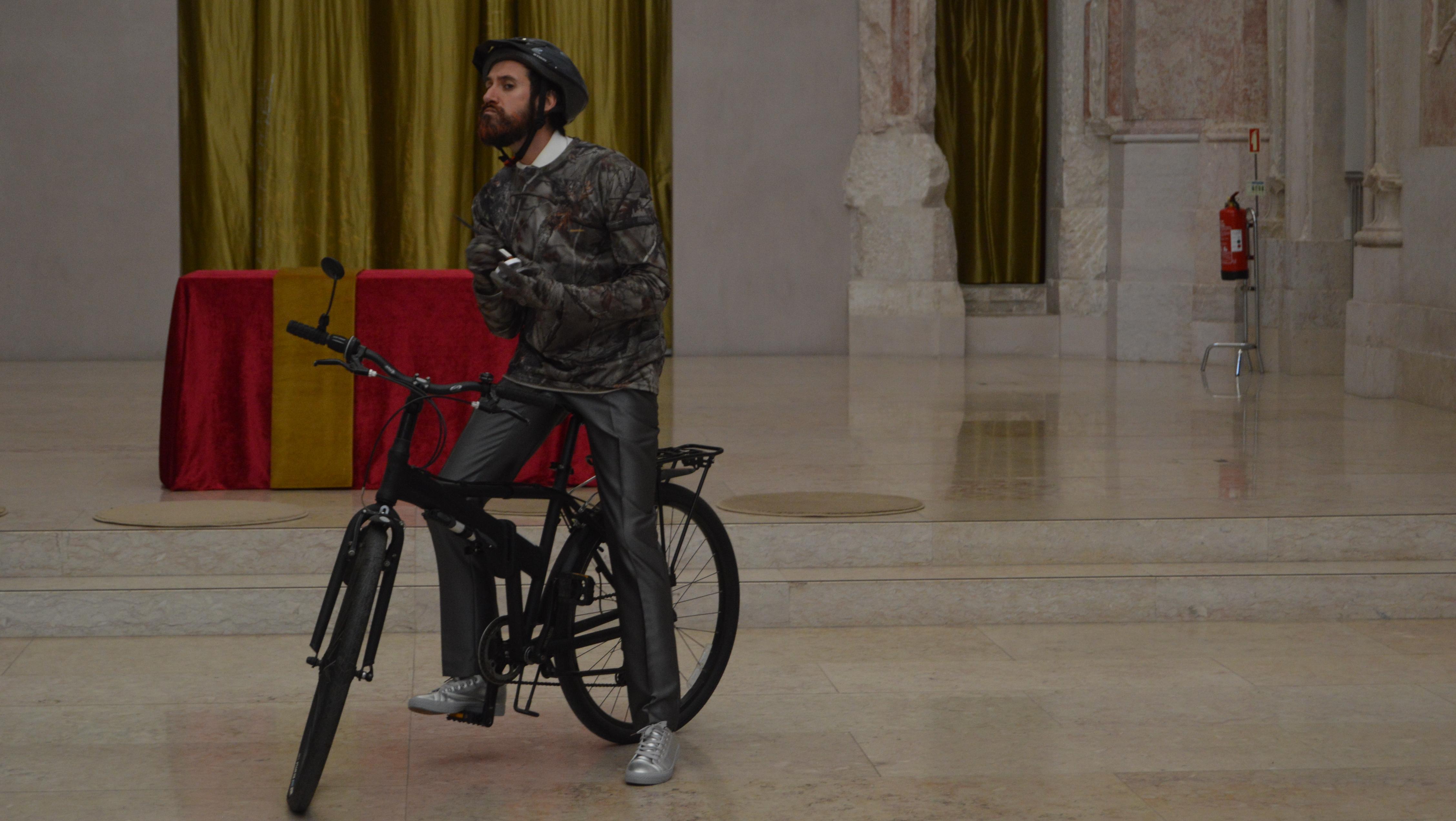 Ator em cima de bicicleta no meio da antiga nave da igreja de S. Julião